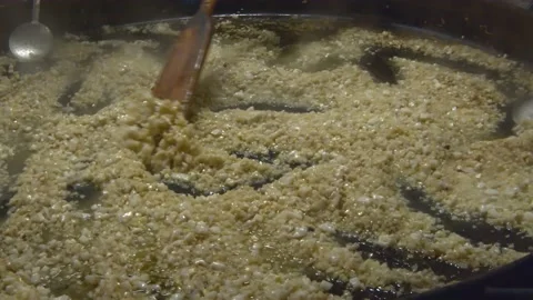 Many people with their hands preparing giant seafood paella. Stock Footage 133714519
