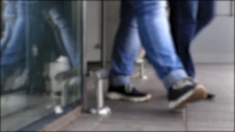 Many people visitors of mall walk through the glass door for shopping. Stock Footage 107828675