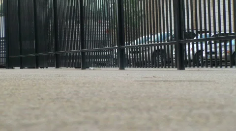 Many people walking by fence at ballpark Stock Footage