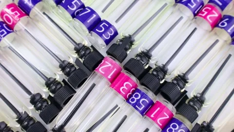 Many perfume samples, colognes and fragrances tester bottles circle rotation Stock Footage 240664542
