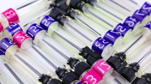 Many perfume samples, colognes and fragrances tester bottles circle rotation Stock Footage 242353575