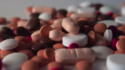 Many pills spill on white background. Different pills falling. Stock Footage 237768989