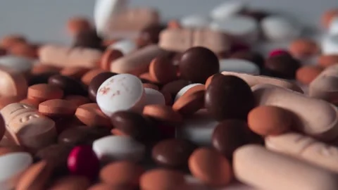 Many pills spill on white background. Different pills falling. Stock Footage 237769009