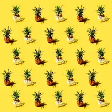 Many pineapples on a solid yellow background pattern Stock Photos