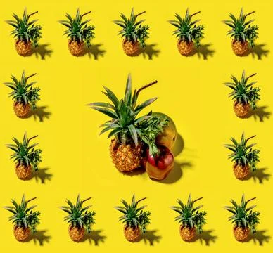Many pineapples on a solid yellow background pattern Stock Photos