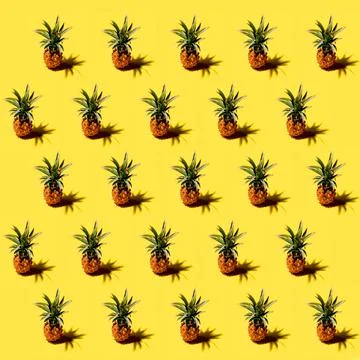 Many pineapples on a solid yellow background pattern Stock Photos