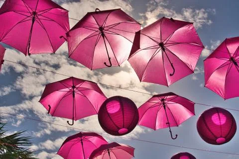 Many pink umbrellas floating recognizing cancer awareness month Stock Photos