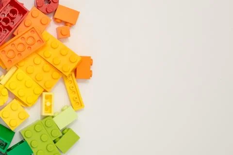 Many plastic constructor cubes on white background. Popular toys. Stock Photos