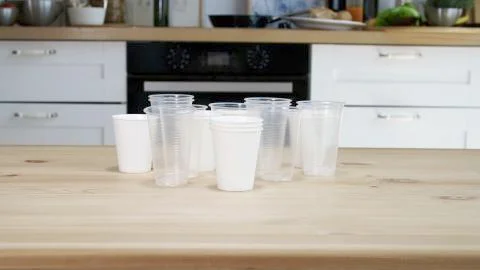 Many of plastic cups are on the table, plastic pollution. Stock Photos