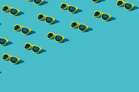 Many plastic sunglasses pattern on turquoise blue background with copy space Stock Photos
