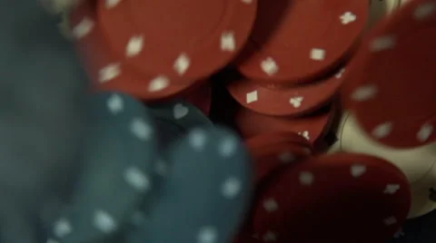Many poker chips are dropped onto a green baize table - slow motion Stock Footage 44103860