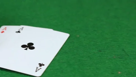 Many poker chips on a green table with cards Stock Footage 100823357