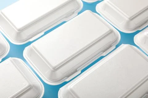 Many polystyrene food containers on blue background Stock Photos
