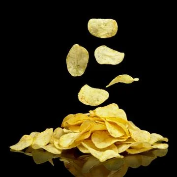Many potato chips with falling chips Stock Photos