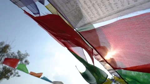 Many prayer flags, are slowly fluttering in the wind in sun backlight. Stock Footage 132105906