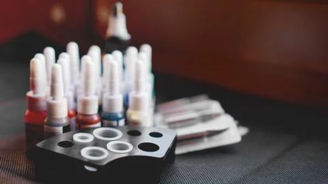 Many professional bottles with colored ink for tattoos Stock Photos