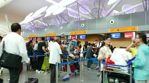Many queue lines to check-in counters in airport concourse, crowded area Stock-Footage 50937912