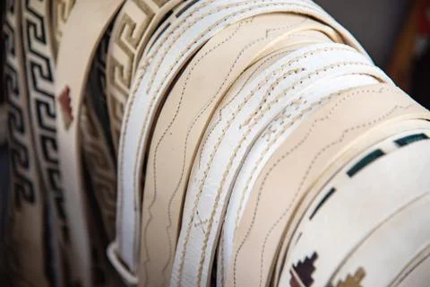 Many rawhide belts with different stitched patterns Stock Photos