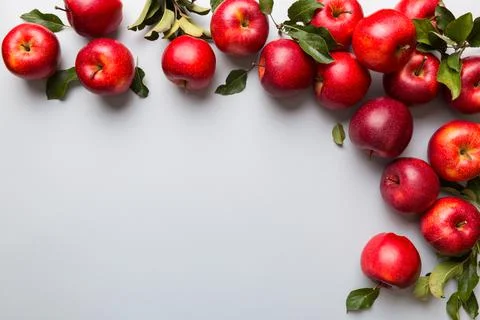 Many red apples on colored background, top view. Autumn pattern with fresh ap Stock Photos