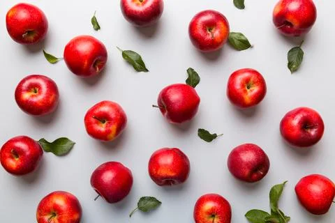 Many red apples on colored background, top view. Autumn pattern with fresh ap Stock Photos