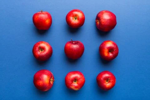 Many red apples on colored background, top view. Autumn pattern with fresh ap Stock Photos