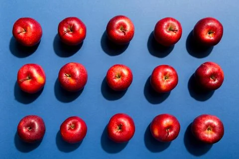 Many red apples on colored background, top view. Autumn pattern with fresh ap Stock Photos