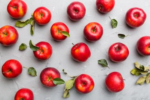 Many red apples on colored background, top view. Autumn pattern with fresh ap Stock Photos