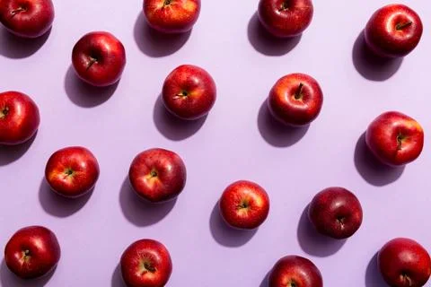 Many red apples on colored background, top view. Autumn pattern with fresh ap Stock Photos
