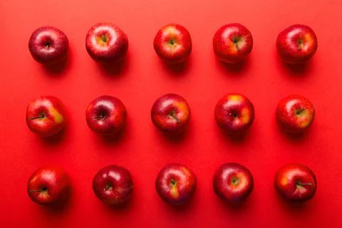 Many red apples on colored background, top view. Autumn pattern with fresh ap Stock Photos