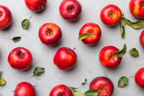 Many red apples on colored background, top view. Autumn pattern with fresh .. Stock Photos