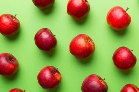 Many red apples on colored background, top view. Autumn pattern with fresh ap Stock Photos