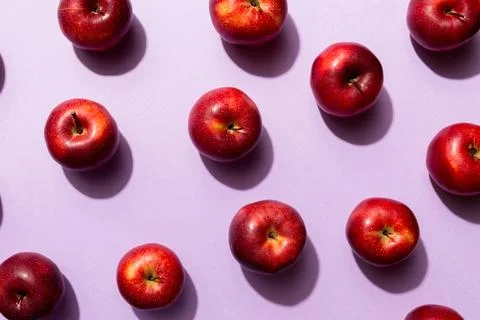 Many red apples on colored background, top view. Autumn pattern with fresh ap Stock Photos