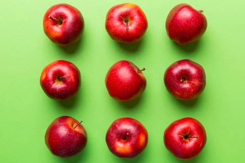 Many red apples on colored background, top view. Autumn pattern with fresh .. Stock Photos