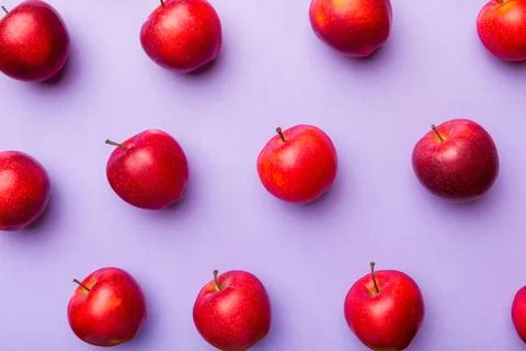 Many red apples on colored background, top view. Autumn pattern with fresh ap Stock Photos