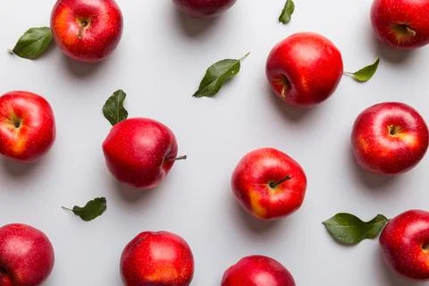 Many red apples on colored background, top view. Autumn pattern with fresh .. Stock Photos