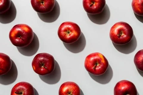 Many red apples on colored background, top view. Autumn pattern with fresh .. Stock Photos