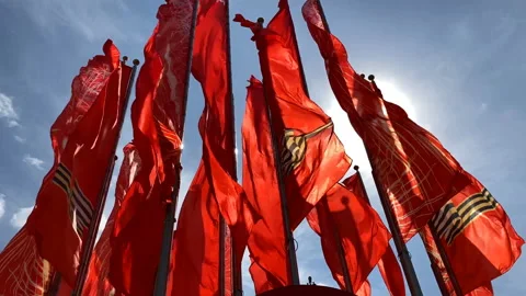 Many red flags waving at the sky with the sun. Stock Footage 153648757