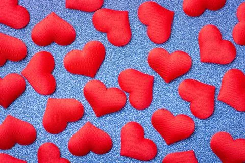 Many red hearts on blue background Stock Photos