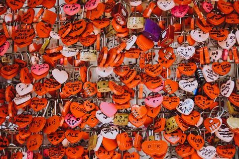 Many red locks in the form of hearts with the names of lovers. Near Juliet's  Stock Photos