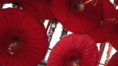 A many red parasol is moving in wind under ceiling, Thailand. Video stock 127010942