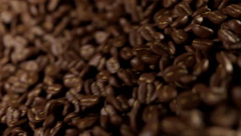 Many roasted coffee beans falling down in slow motion. 스톡 동영상 328608946