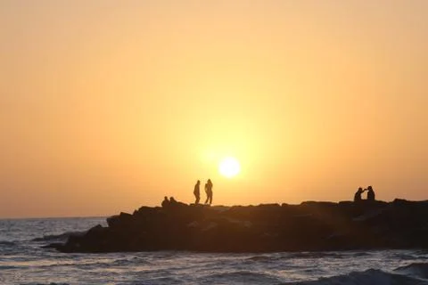 Many on rocks distant Stock Photos