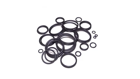 Many round rubber gaskets for sanitary fittings on a white background looped Stock Footage 72128917