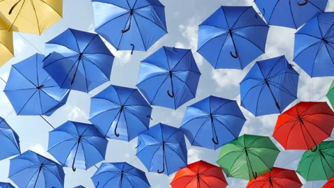 Many rows of colourful decorative umbrellas on the wind. Slider view Stock Footage 95439903