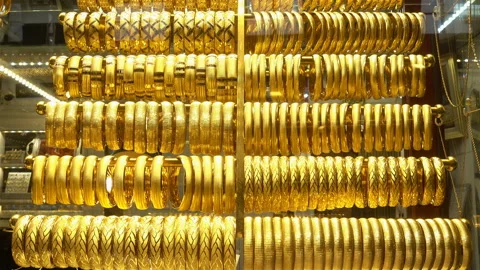 Many rows of gold bracelets hang on coasters in 4k Stock Footage 126143396