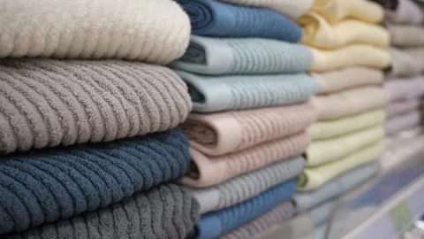 Many rows of multi-colored towels on the shelf. 스톡 동영상 312231935