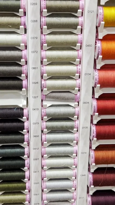 Many rows of spools for threads of different colors for sewing machines and Stock-Footage 250386402