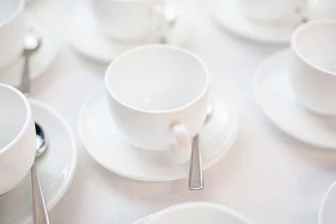 Many rows of white ceramic coffee or tea cups. Lines of coffee cups Stock Photos