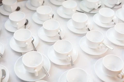 Many rows of white ceramic coffee or tea cups. Lines of coffee cups Stock Photos