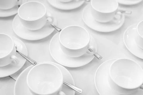 Many rows of white ceramic coffee or tea cups. Lines of coffee cups Stock Photos